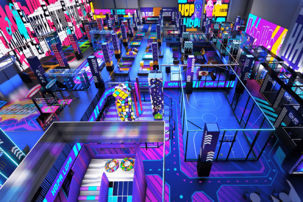 cyberpunk themed indoor playground with neon accents and futuristic play structures designed to attract teens and families.